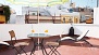 Seville Apartment - Charming terrace with table, chairs and deck chairs.