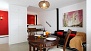 Seville Apartment - Open-spaced room with sofa and table.