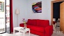 S&eacute;ville Appartement - Bright living room with a large window. The master bedroom is just seen beyond.
