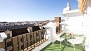 Seville Apartment - The terrace is equipped with outdoor furniture and a sun canopy.