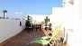 Seville Apartment - Terrace with deckchairs, table and chairs.