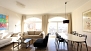 Seville Apartment - Open-spaced living area with 2 large windows.
