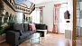 Seville Apartment - Living area with sofa, coffee table and TV.