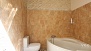 Seville Apartment - Bathroom 1 features a large corner bathtub.