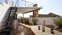 Seville Apartment - Lower terrace with table and chairs. Stairs lead to the upper terrace.