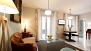Seville Apartment - Living area has 2 windows facing Celinda street. The door at the end opens to the kitchen.